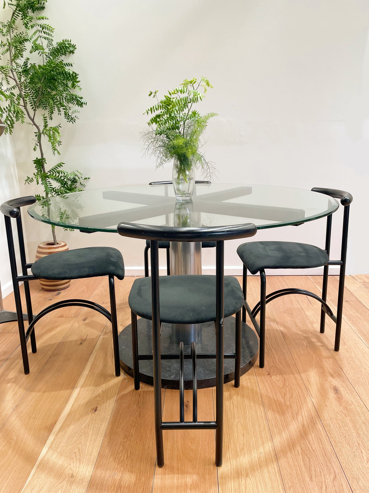 Italian glass dining table with designer Tokyo chairs by Rodney Kinsman for Bieffleplast